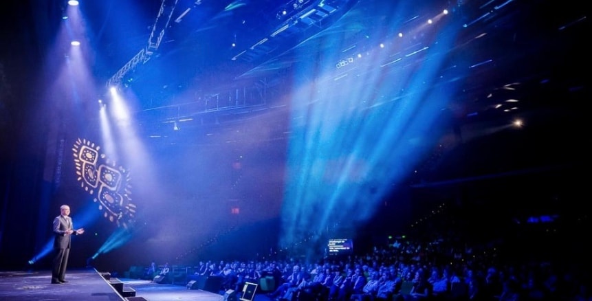 Michael Taylor speaking on stage with audience